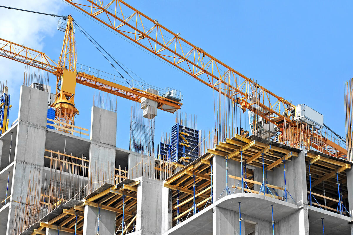 crane and building construction against blue sky