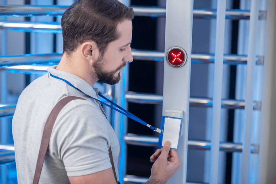 man scanning badge on access control gates