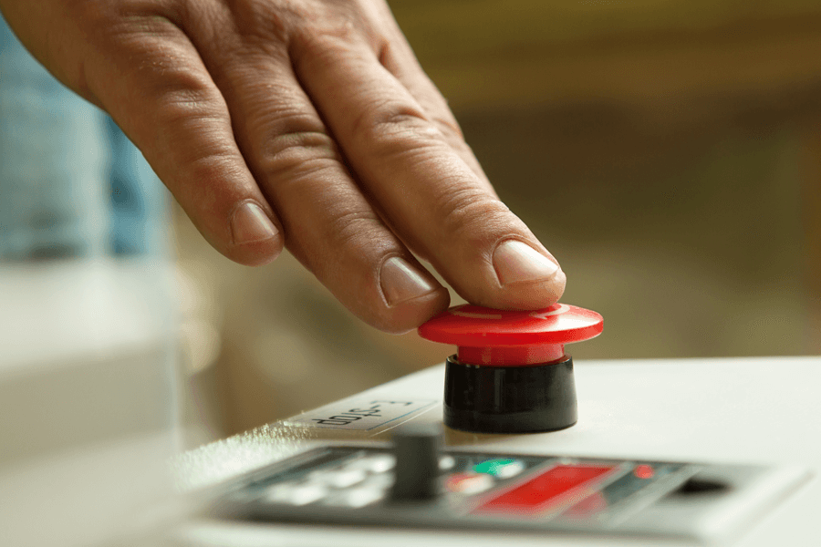 red button being pushed on control panel