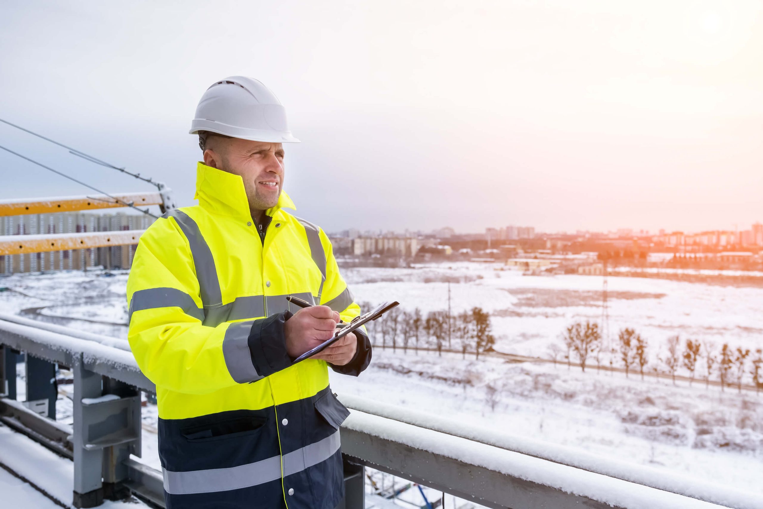 Worker standing on a construction site in high-vis in winter