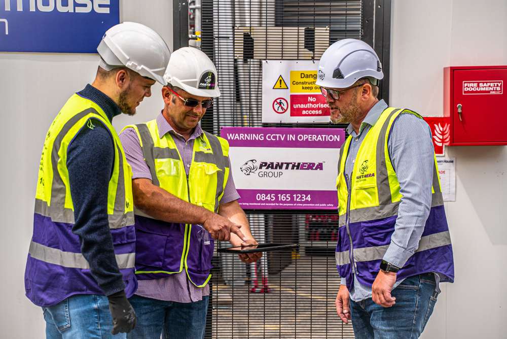 construction workers looking at plans on a tablet