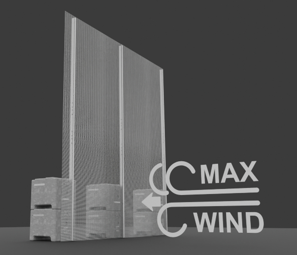 An image of a temporary high-security fence system with a tall, wire mesh panel and its ballast blocks, similar to the previous image. The render is against a gray background, but this one includes a white graphic on the right side with an arrow pointing at the fence and the words "MAX WIND", indicating its wind resistance